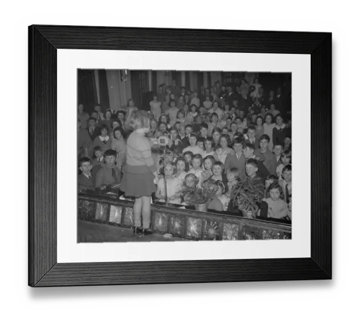 Framed Print : A little girl entertains the audience of children at the childrens party Framed Print : A little girl entertains the audience of children at the childrens party