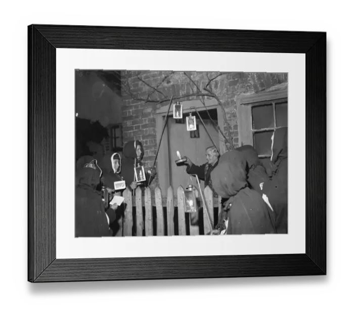 Framed Print : An Eynsford resident has a visit from hooded carol singers. 1935