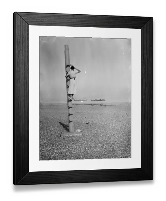Framed Print : A woman stands on the outlook post on Dungeness beach in Kent. 1936