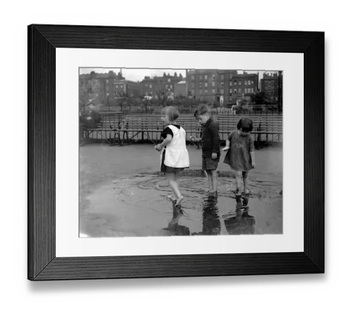 Framed Print : Small children paddling in a puddle in Wapping, London. 1933 Framed Print : Small children paddling in a puddle in Wapping, London. 1933