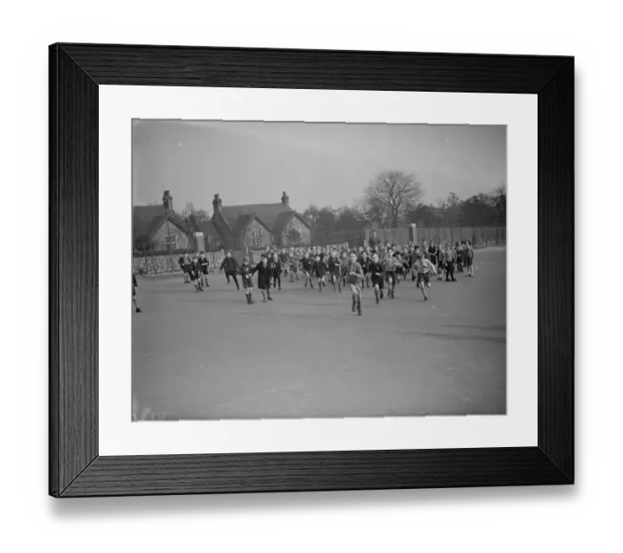 Framed Print : School children rush out onto the school playground at break time in Erith, Kent Framed Print : School children rush out onto the school playground at break time in Erith, Kent