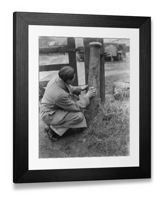 Framed Print : A man uses a cloth to try and clean a boundary post. 1937 Framed Print : A man uses a cloth to try and clean a boundary post. 1937