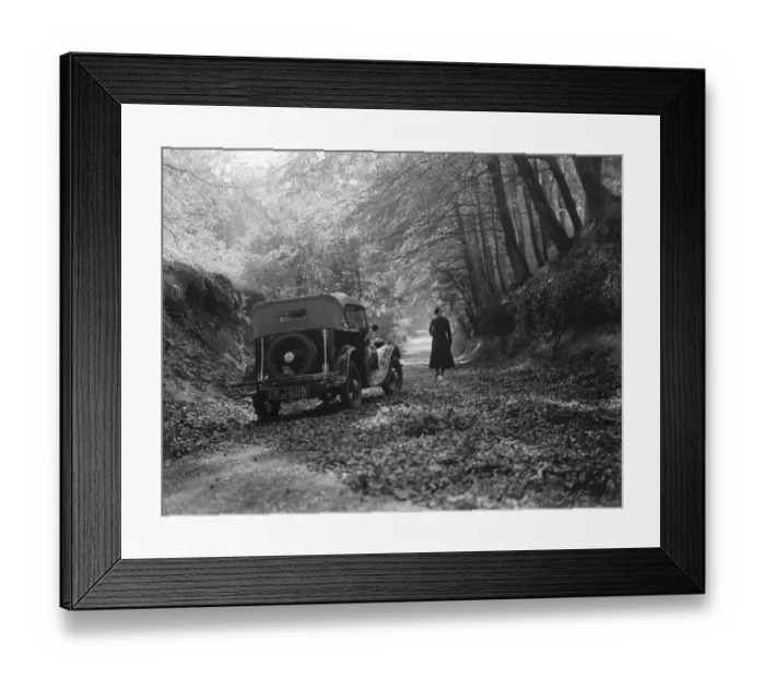 Framed Print : A woman taking in the woodland scene next to a parked sports car. 1936 Framed Print : A woman taking in the woodland scene next to a parked sports car. 1936