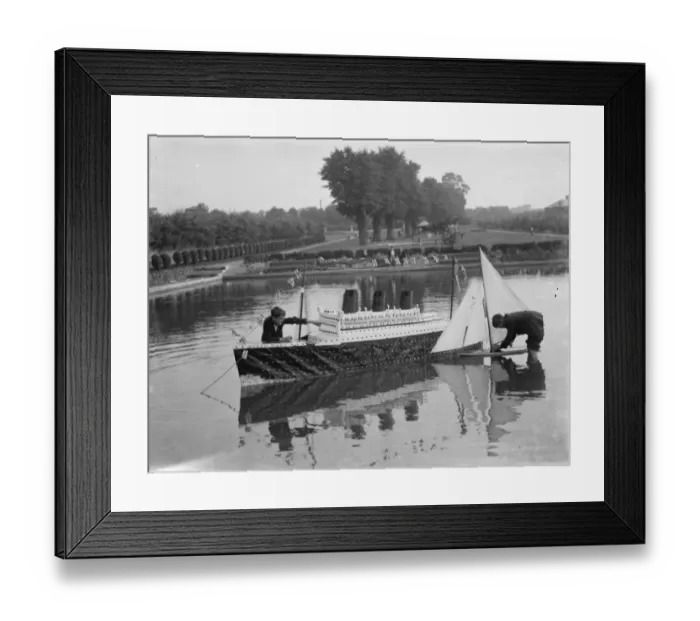 Framed Print : Model of the liner RMS Queen Mary is released upon the the water alongside a model yacht Framed Print : Model of the liner RMS Queen Mary is released upon the the water alongside a model yacht