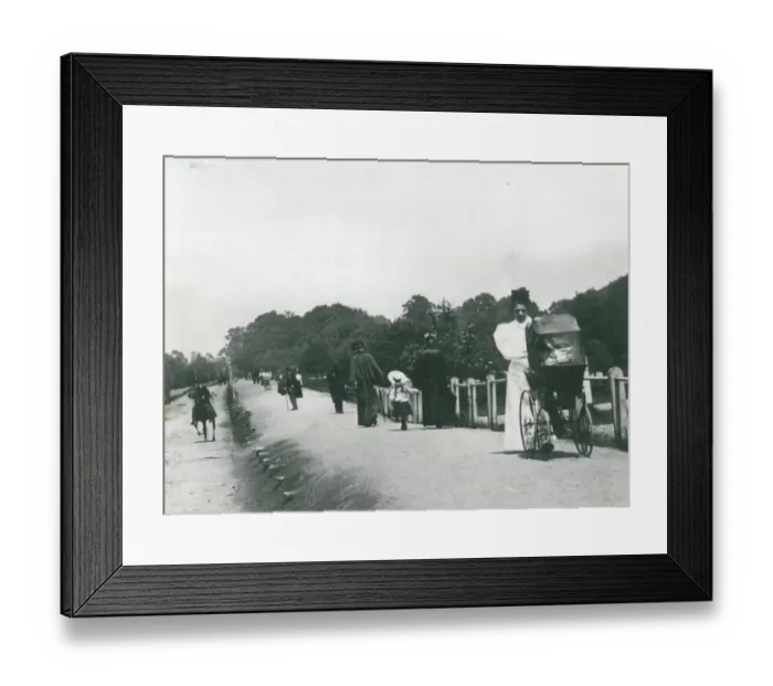 Framed Print : Nannies taking babies in perambulators and going for walks with children along Framed Print : Nannies taking babies in perambulators and going for walks with children along