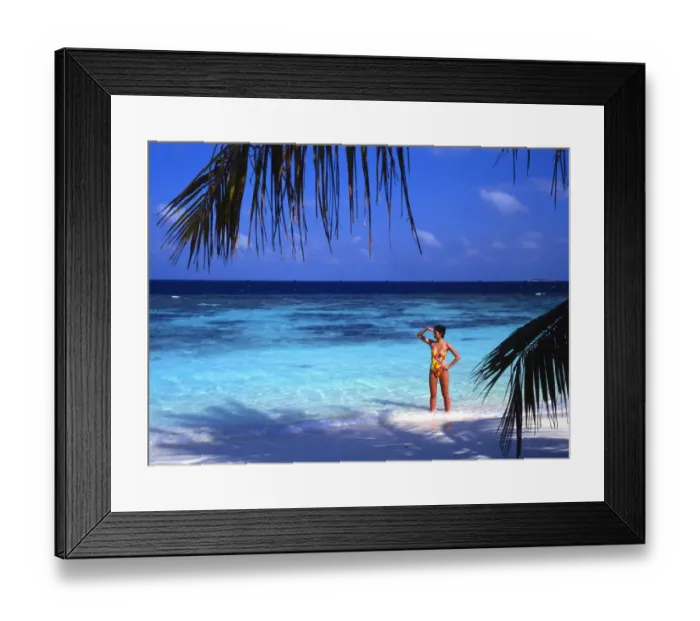 Framed Print : Girl standing on beach of the island of Bandos, in the Maldives Framed Print : Girl standing on beach of the island of Bandos, in the Maldives