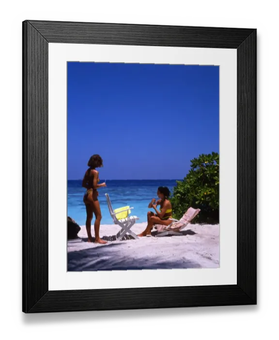 Framed Print : Two young women on the beach of Bandos Island, the Maldives