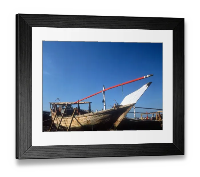 Framed Print : KUWAIT - A traditional cargo boat drawn up on the Gulf sands Framed Print : KUWAIT - A traditional cargo boat drawn up on the Gulf sands