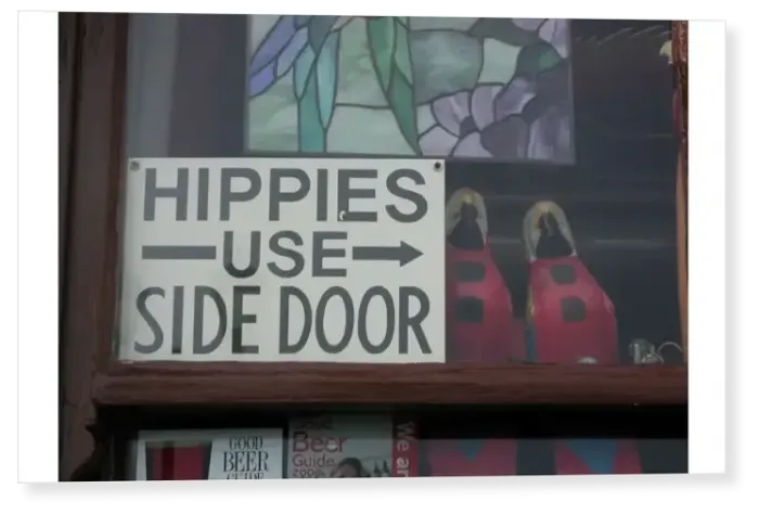 Print : Humorous notice in window of pub: Hippies use side door, Deal, Kent, England Print : Humorous notice in window of pub: Hippies use side door, Deal, Kent, England