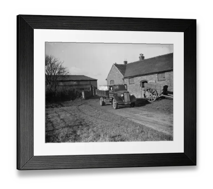 Framed Print : A milk lorry full of milk churns leaves the farmyard. 1937 Framed Print : A milk lorry full of milk churns leaves the farmyard. 1937