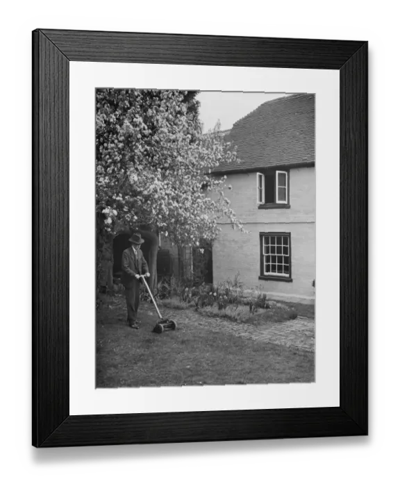 Framed Print : An elderly man cuts the grass at his cottage garden in Farningham, Kent. 7 April 1938 Framed Print : An elderly man cuts the grass at his cottage garden in Farningham, Kent. 7 April 1938