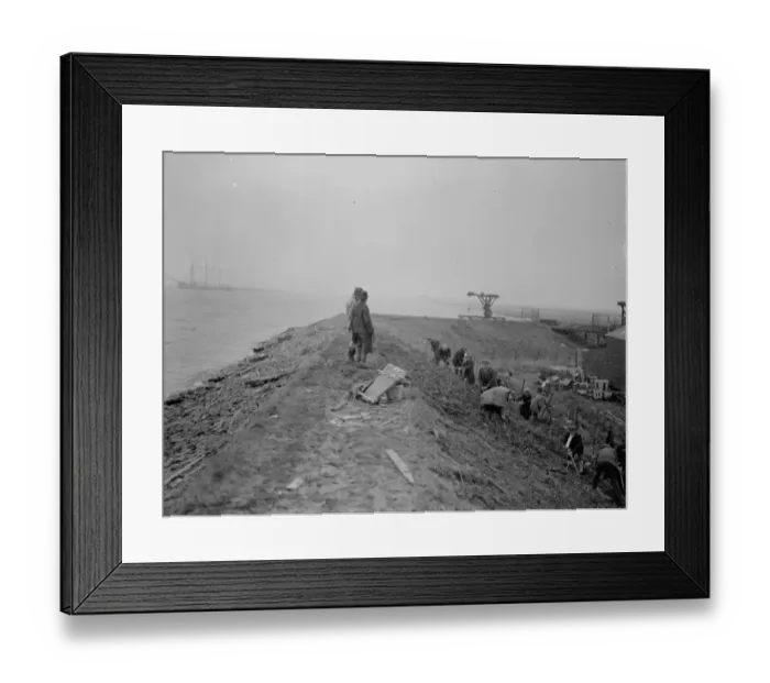 Framed Print : Workers maintaining the river defences and doing repairs on the river wall and embankment Framed Print : Workers maintaining the river defences and doing repairs on the river wall and embankment