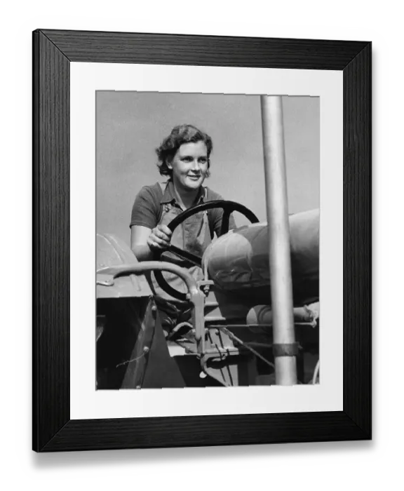 Framed Print : Land Girl driving a tractor during WW2 - a girl now in training for the Womens Framed Print : Land Girl driving a tractor during WW2 - a girl now in training for the Womens