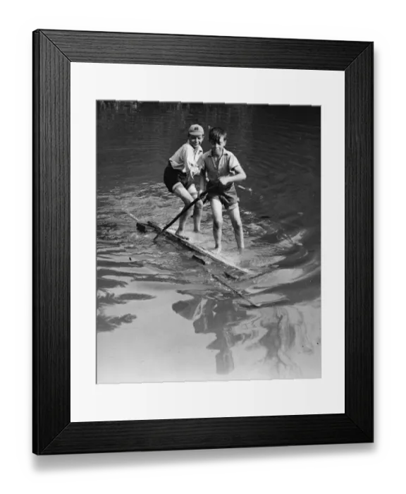 Framed Print : Boys have good fun with an improvised raft on the village pond at Orpington, Kent Framed Print : Boys have good fun with an improvised raft on the village pond at Orpington, Kent