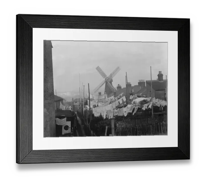 Framed Print : Rochester windmill in Kent, seen from behind the washing lines. 1936 Framed Print : Rochester windmill in Kent, seen from behind the washing lines. 1936