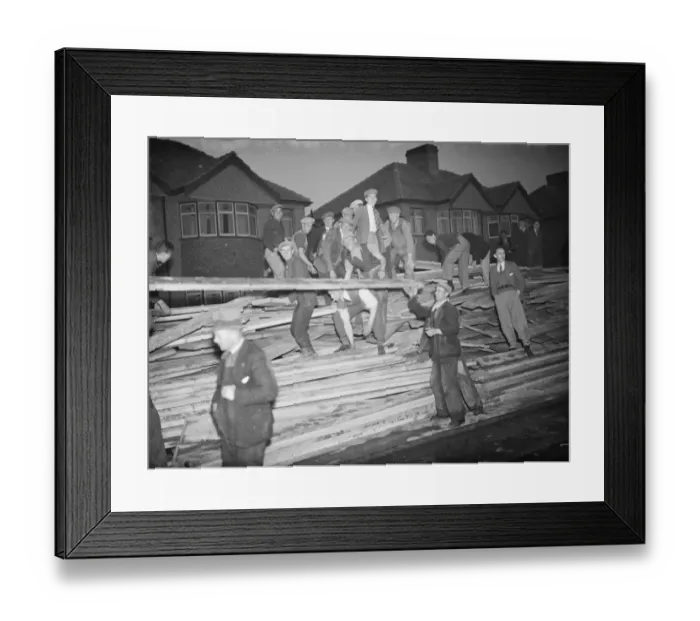 Framed Print : Men rescuing timber from the fire at the timber yard in Welling in Kent Framed Print : Men rescuing timber from the fire at the timber yard in Welling in Kent