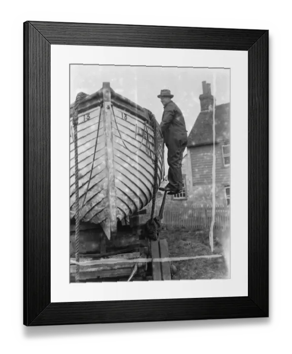 Framed Print : A policeman builds a boat on the village green in Faversham, Kent. 1937 Framed Print : A policeman builds a boat on the village green in Faversham, Kent. 1937