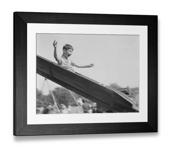Framed Print : A young boy on a slide in Dartford, Kent. 1939 Framed Print : A young boy on a slide in Dartford, Kent. 1939