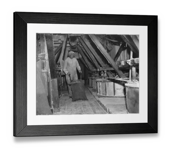 Framed Print : A worker shifting a sack with a trolley at the old fashioned flour mill in Erith, London Framed Print : A worker shifting a sack with a trolley at the old fashioned flour mill in Erith, London