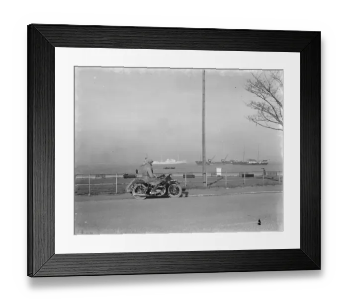 Framed Print : A motorcyclist looks out at the traffic on the Thames estuary from Gravesend promenade