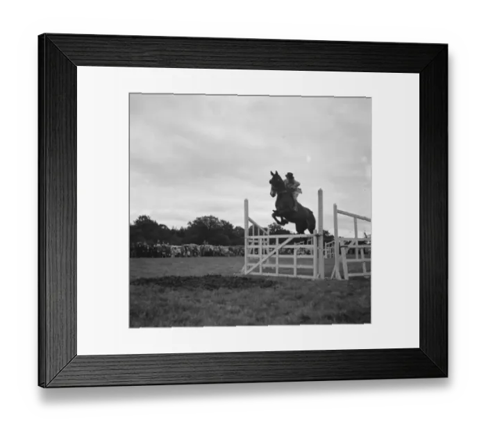Framed Print : Westerham Hill Horse Show, Kent. A rider and his horse make a jump Framed Print : Westerham Hill Horse Show, Kent. A rider and his horse make a jump