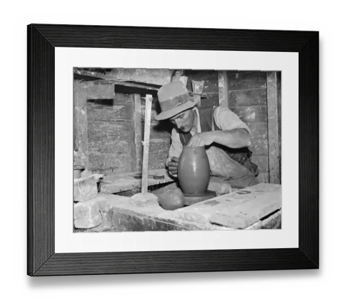Framed Print : Pottery maker Mr Sadler moulding clay on a potters wheel. 1938