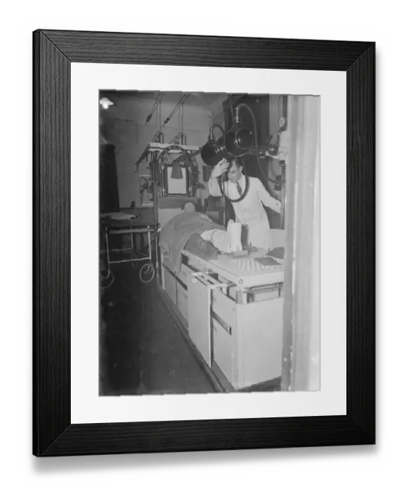 Framed Print : Gravesend Hospital in Kent. The X-ray department. A patient has a scan of his