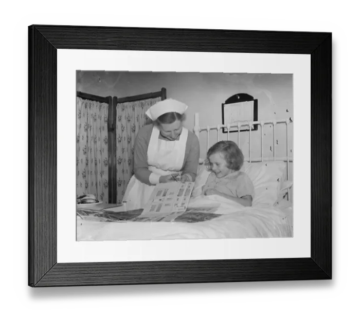Framed Print : The Sidcup Cottage Hospital in Kent. Nurse Wendy Saunders is helping a little Framed Print : The Sidcup Cottage Hospital in Kent. Nurse Wendy Saunders is helping a little