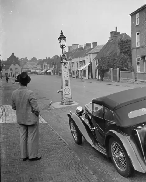 An old water pump used as a street lamp. West Malling. 14 September 1937