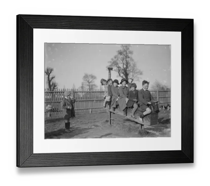 Framed Print : Children play on a rocking horse in a playground. 1936 Framed Print : Children play on a rocking horse in a playground. 1936
