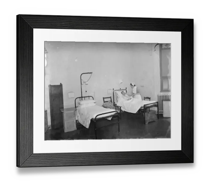 Framed Print : The Sidcup Cottage Hospital in Kent. A nurse tends to a patient in the mens ward Framed Print : The Sidcup Cottage Hospital in Kent. A nurse tends to a patient in the mens ward