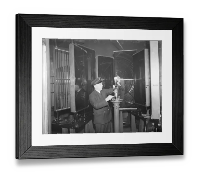Framed Print : A lighthouse keeper checks the Dungeness lighthouse bulb in the lantern room Framed Print : A lighthouse keeper checks the Dungeness lighthouse bulb in the lantern room