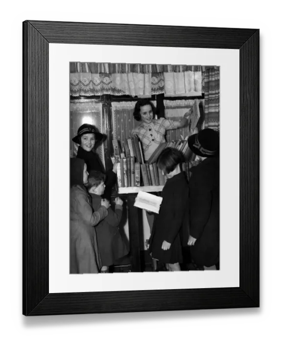 Framed Print : Young girl running a lending library for other schoolchildren. 1940 s Framed Print : Young girl running a lending library for other schoolchildren. 1940 s