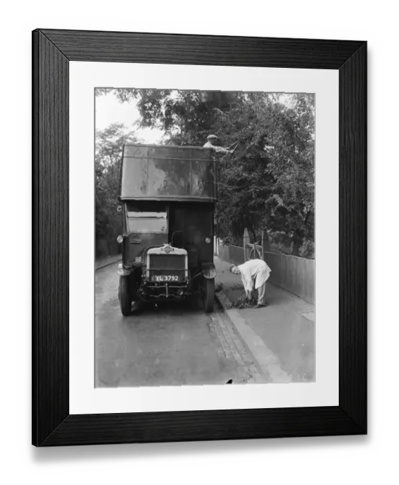Framed Print : Maintenance men use a double decker bus to trim the overhanging tree branches above Framed Print : Maintenance men use a double decker bus to trim the overhanging tree branches above