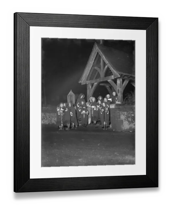 Framed Print : Young hooded carol singers singing by the lych gate outside Eynsford church, Kent Framed Print : Young hooded carol singers singing by the lych gate outside Eynsford church, Kent