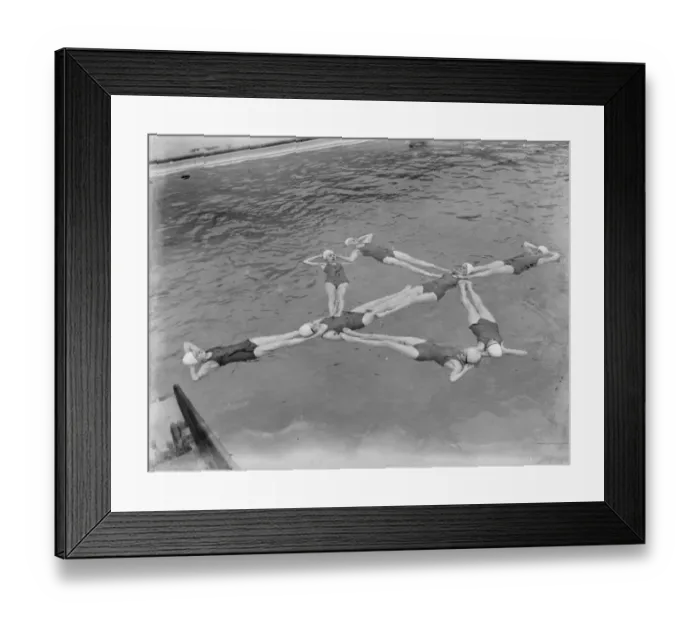 Framed Print : A synchronized swimming group perform a floating display at the opening for the new Framed Print : A synchronized swimming group perform a floating display at the opening for the new