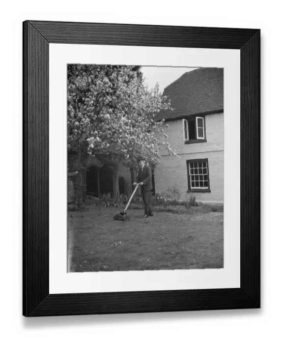Framed Print : An elderly man cuts the grass at his cottage garden in Farningham, Kent. 7 April 1938 Framed Print : An elderly man cuts the grass at his cottage garden in Farningham, Kent. 7 April 1938