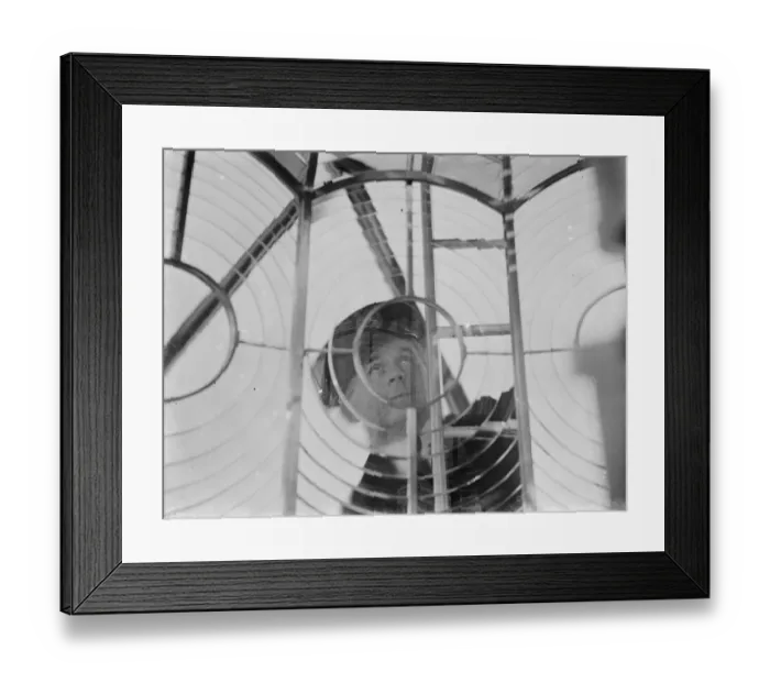 Framed Print : A lighthouse keeper checks the Dungeness lighthouse lantern glass in the lantern room Framed Print : A lighthouse keeper checks the Dungeness lighthouse lantern glass in the lantern room