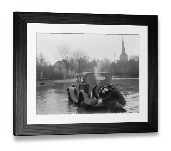 Framed Print : Flooding in Eynsford, Kent. A motorist uses a hose to extend the exhaust of his