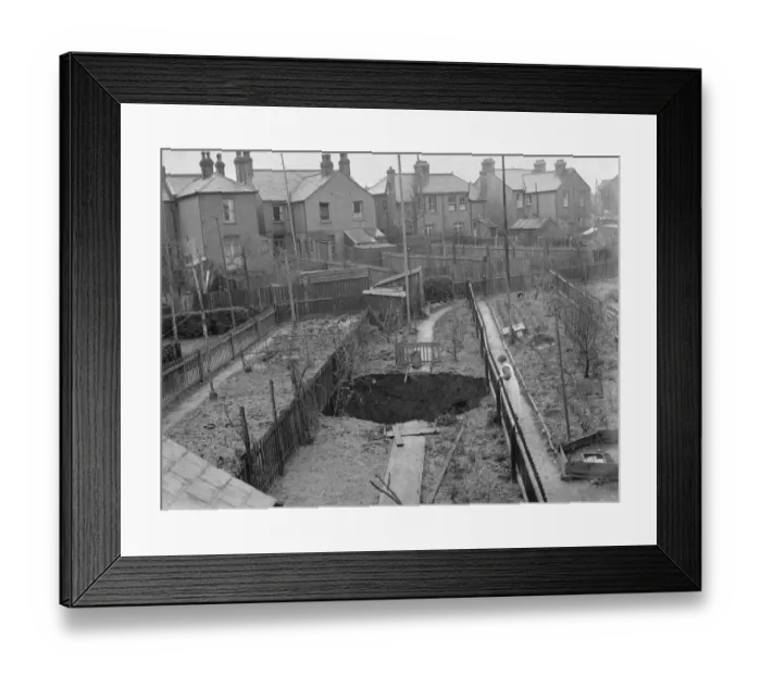 Framed Print : A sinkhole has opened up in peoples gardens in Dartford, Kent. 1937 Framed Print : A sinkhole has opened up in peoples gardens in Dartford, Kent. 1937