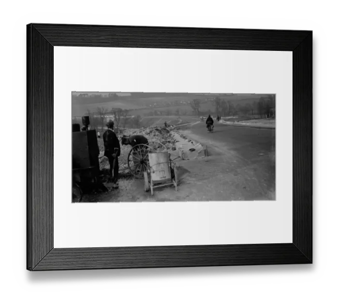 Framed Print : Workmen lay the foundations for road banking along the edges of the road in Farningham Framed Print : Workmen lay the foundations for road banking along the edges of the road in Farningham