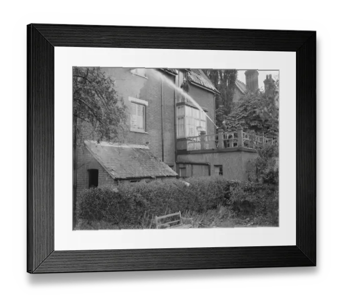 Framed Print : Firemen respond to a house fire in Chislehurst, Kent. A fireman hoses water into Framed Print : Firemen respond to a house fire in Chislehurst, Kent. A fireman hoses water into