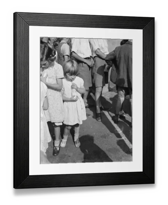 Framed Print : Free milk for children on holiday in Crayford, Kent. A little girl sips her milk Framed Print : Free milk for children on holiday in Crayford, Kent. A little girl sips her milk