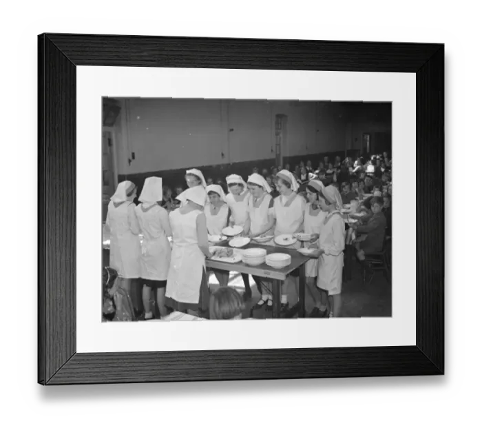 Framed Print : Dinner at East Central School in Dartford, Kent. The girls line up their food