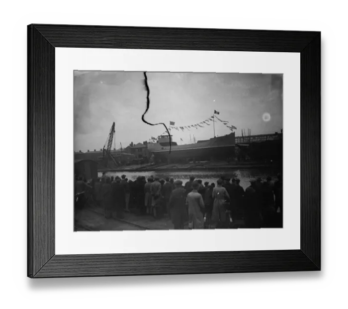 Framed Print : Spectators wait to see the new ship launch as the ship sits broadside on the slipway Framed Print : Spectators wait to see the new ship launch as the ship sits broadside on the slipway