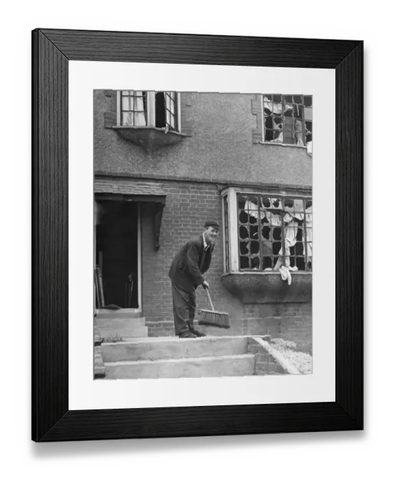 Framed Print : Schoolboy sweeping debris after his Gravesend home in Kent had been damaged by a Framed Print : Schoolboy sweeping debris after his Gravesend home in Kent had been damaged by a