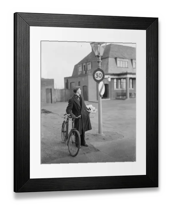 Framed Print : A man looking at a 30 miles per hour speed limit sign in Birchwood, Kent