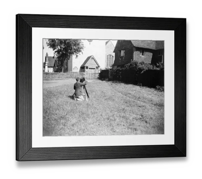 Framed Print : A cameraman filming in front of the village church in Otford, Kent. 1933 Framed Print : A cameraman filming in front of the village church in Otford, Kent. 1933