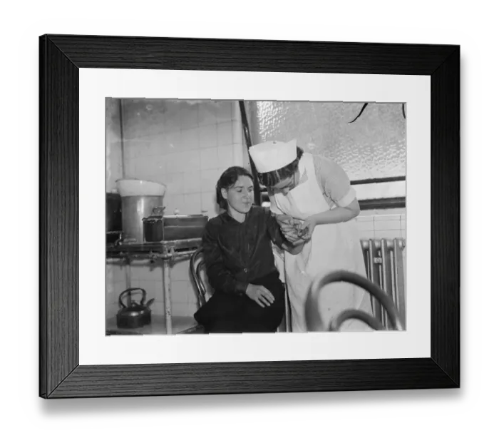 Framed Print : Gravesend hospital series. Nurse tending to a casualty. 1939 Framed Print : Gravesend hospital series. Nurse tending to a casualty. 1939
