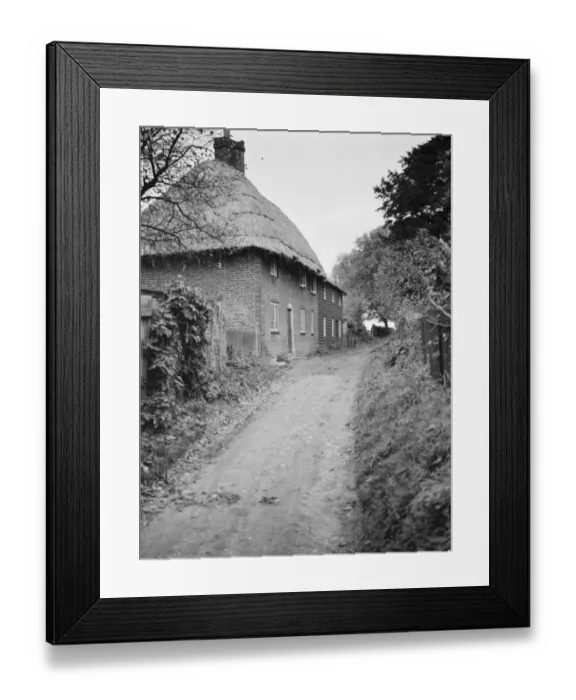 Framed Print : A lane past thatched cottages at Womenswold, Kent. 1937 Framed Print : A lane past thatched cottages at Womenswold, Kent. 1937